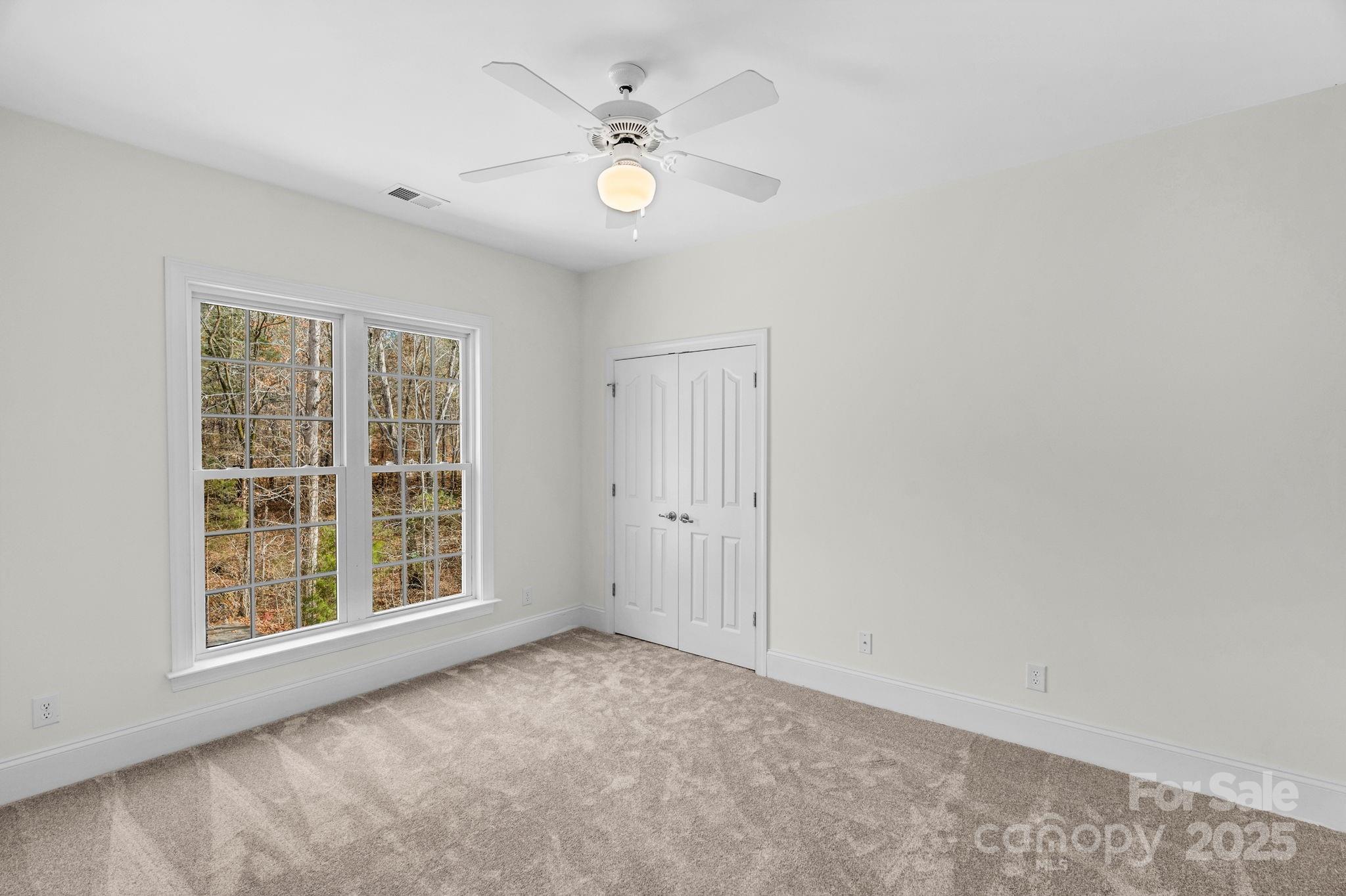 1300 Longleaf Court Weddington, NC 28104 - Photo 38 of 48 an empty room with windows and ceiling fan