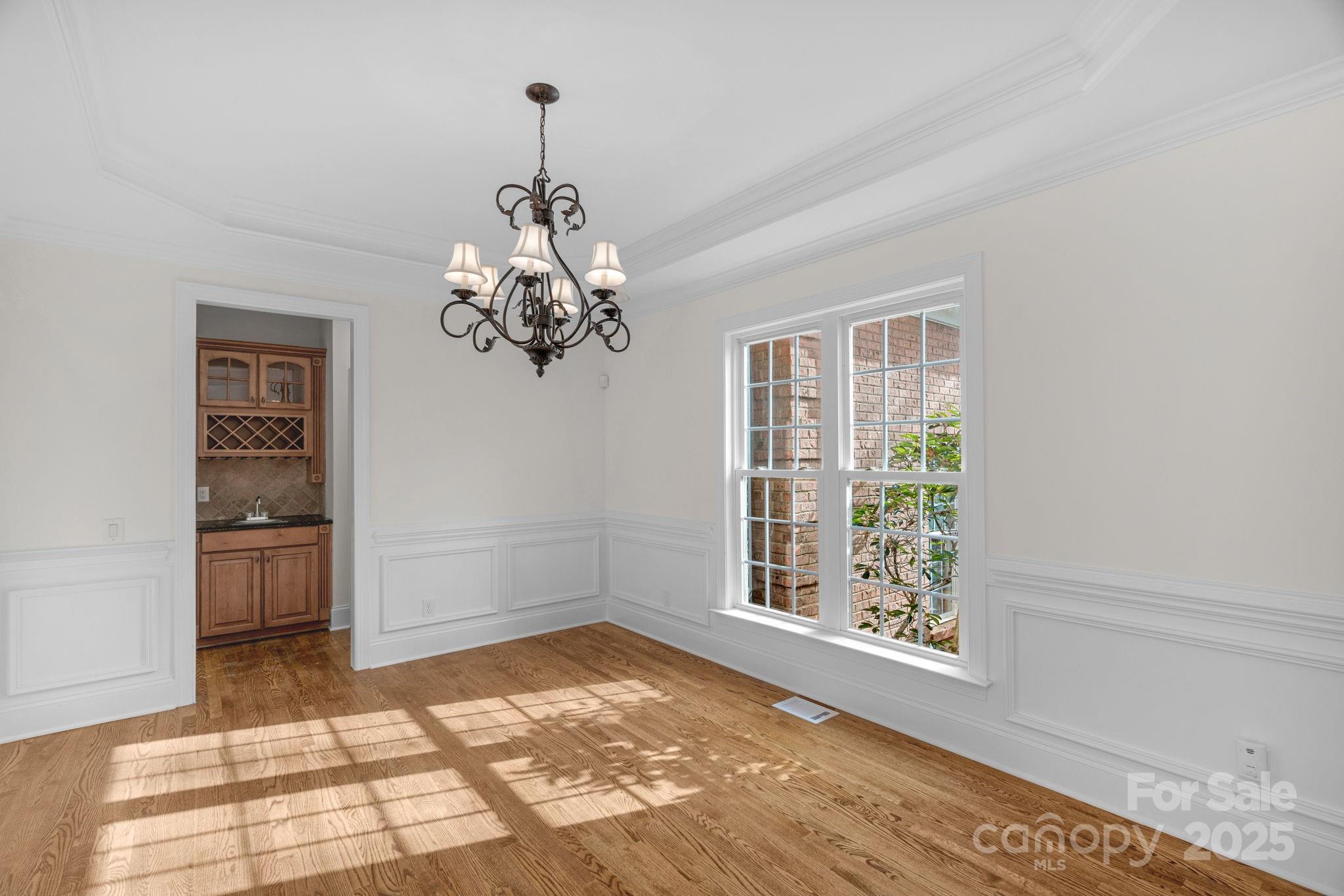 1300 Longleaf Court Weddington, NC 28104 - Photo 6 of 48 a view of a room with a window and chandelier
