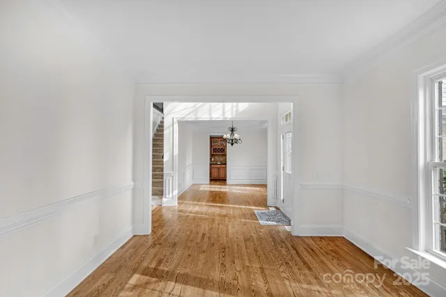 a view of a room with wooden floor and large windows