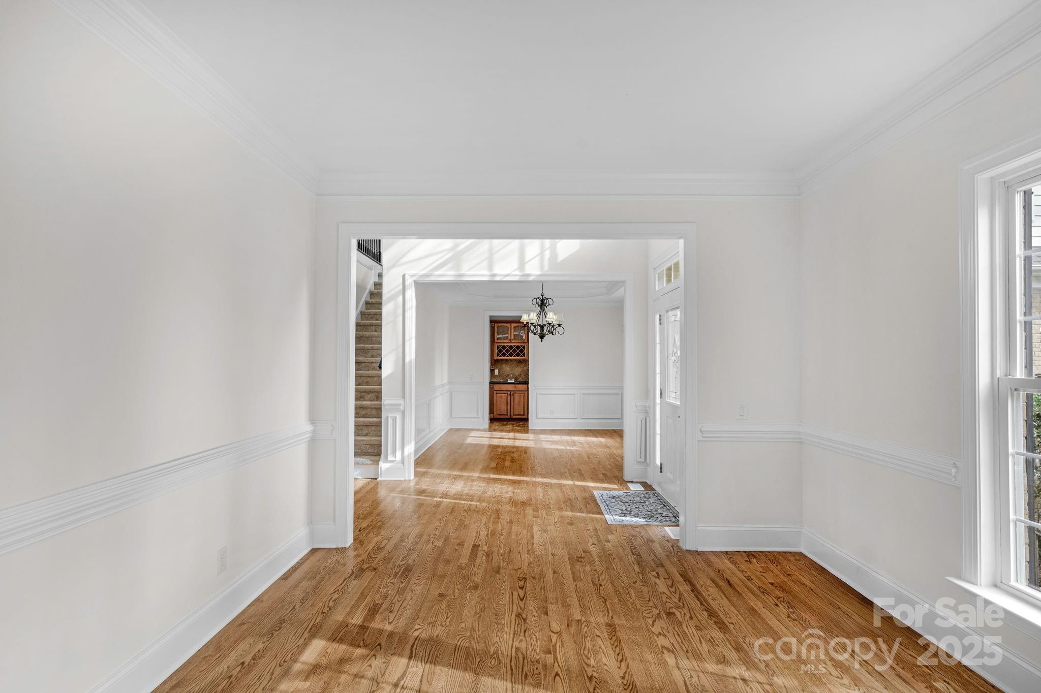 1300 Longleaf Court Weddington, NC 28104 - Photo 7 of 48 a view of a room with wooden floor and large windows