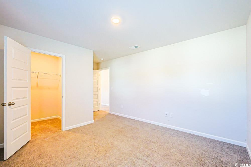 1560 Swing Bridge Way Myrtle Beach, SC 29588 - Photo 19 of 35 Unfurnished bedroom with a spacious closet, light carpet, and recessed lighting
