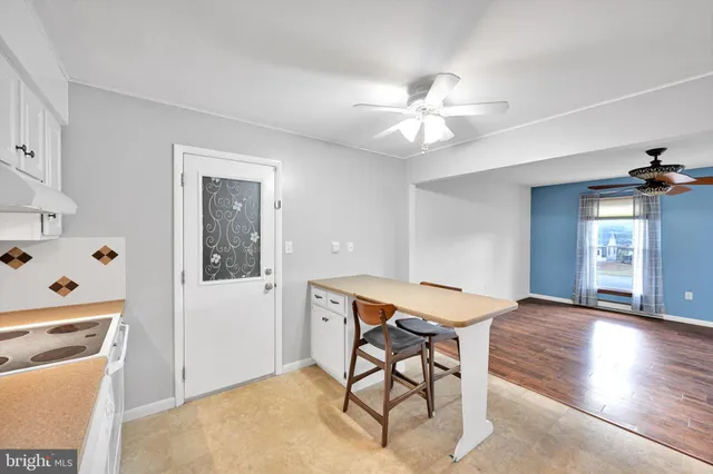 a view of a room with furniture and wooden floor