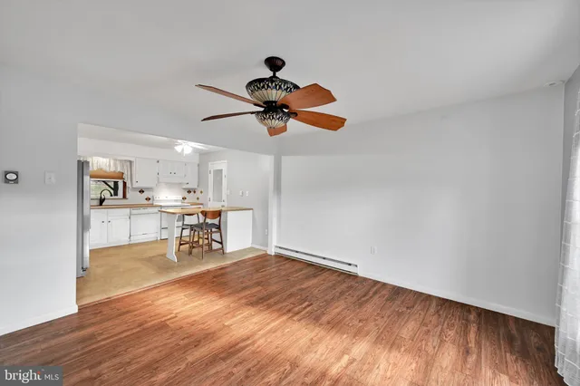 a view of a workspace with wooden floor and a window