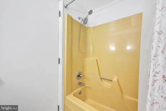 a bathroom with a shower and a bath tub