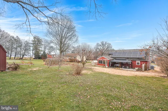 a view of a house with a yard and a car park fire pit