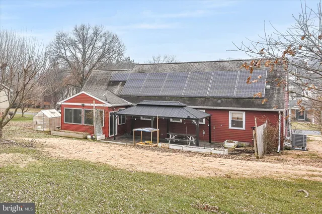 a view of a house with a yard and sitting area
