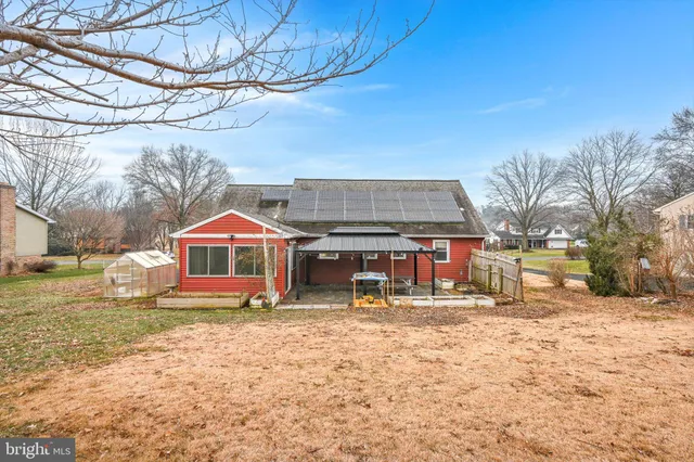 a front view of a house with a yard covered in snow