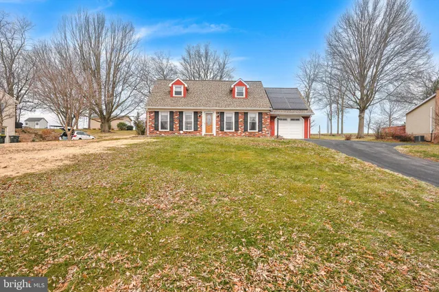 a front view of house with yard and trees