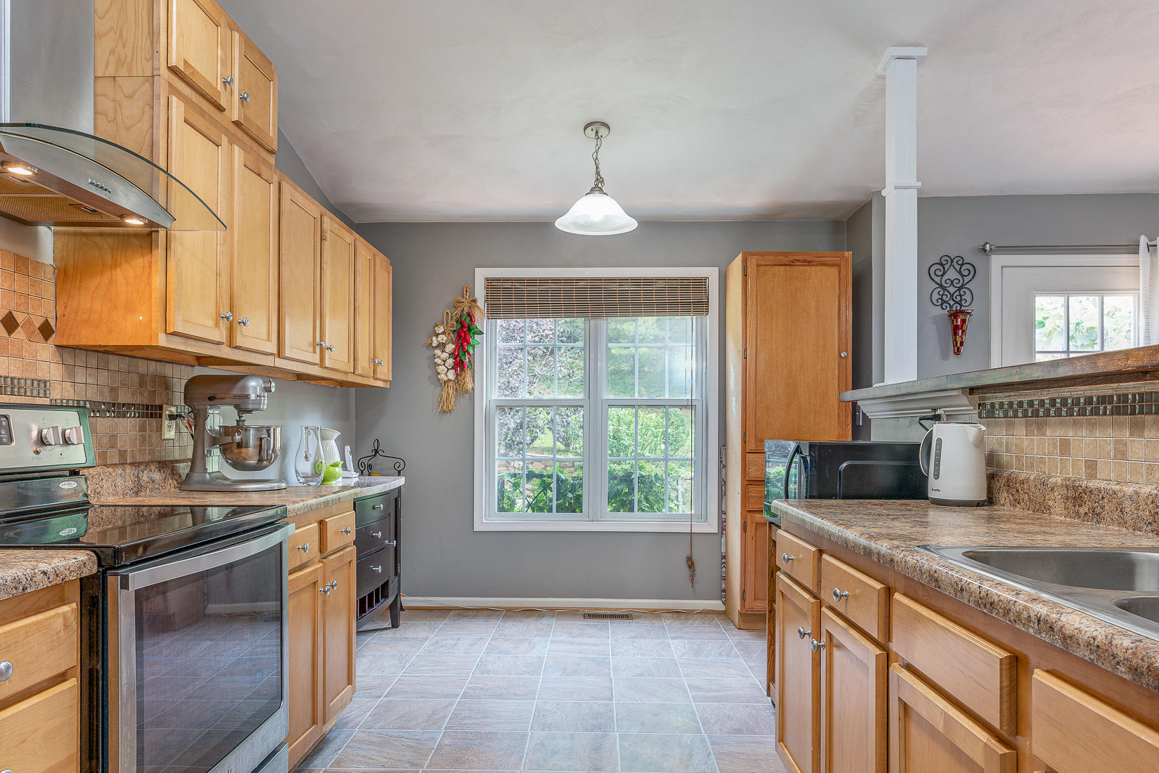 4245 Daugherty Road Salem, VA 24153 - Photo 12 of 44 a kitchen with stainless steel appliances granite countertop a sink stove and cabinets