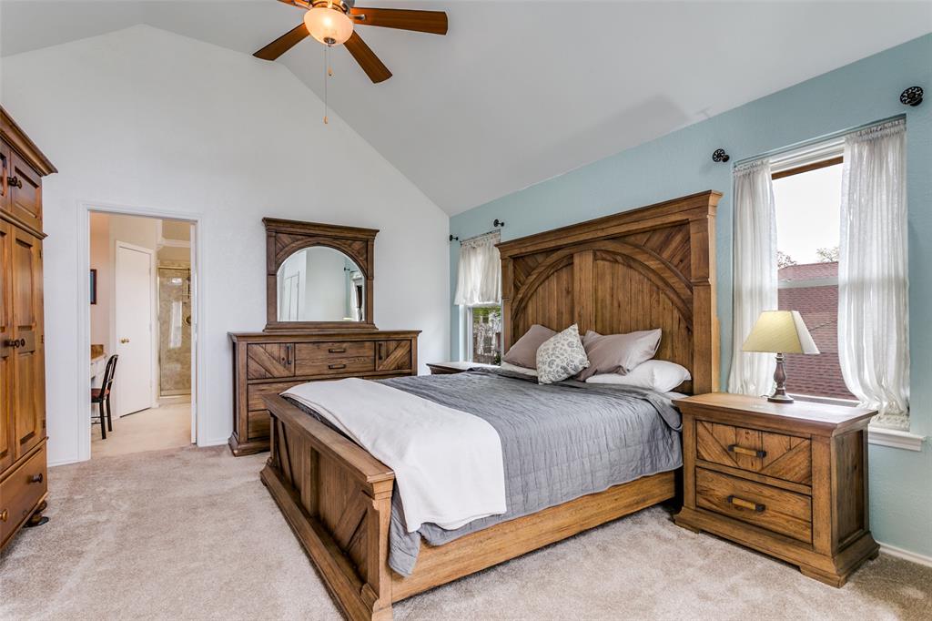 3438 Spring Willow Drive Grapevine, TX 76051 - Photo 12 of 27 a bedroom with a bed a dresser and a chandelier
