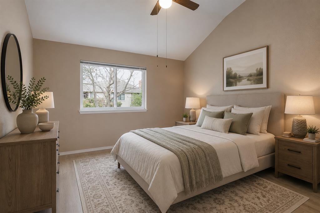 3438 Spring Willow Drive Grapevine, TX 76051 - Photo 15 of 23 Virtual staging.Vaulted ceiling bedroom featuring wood-finish flooring, a ceiling fan, and a large window
