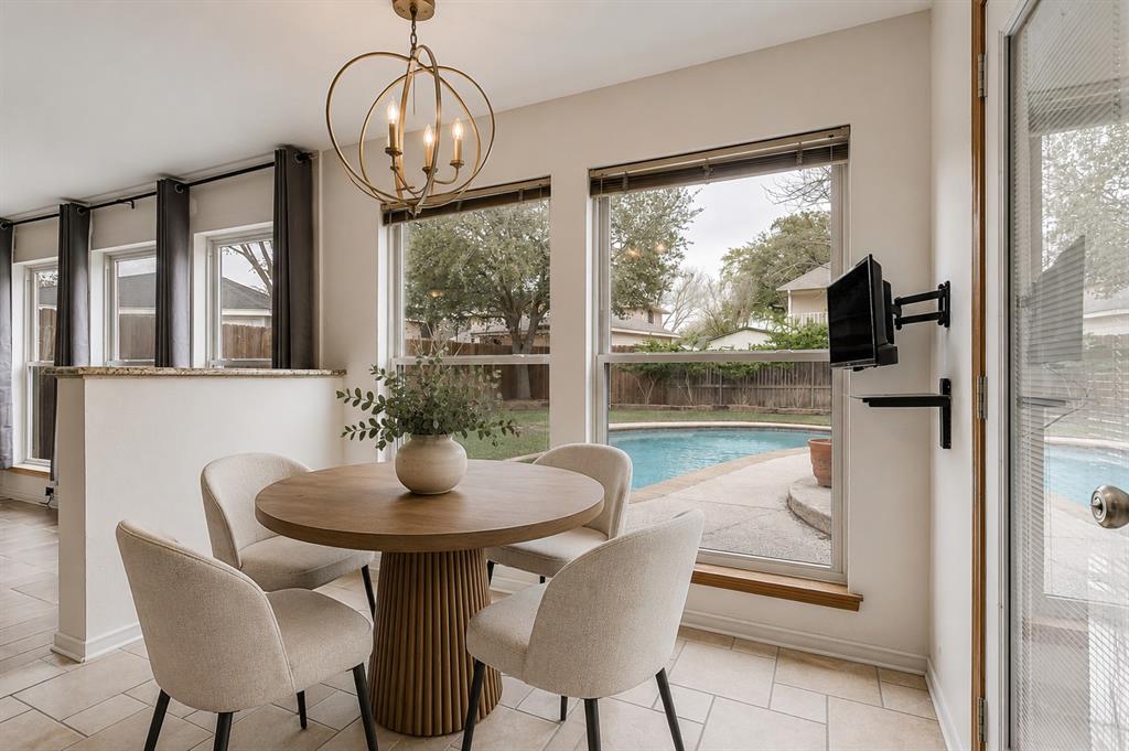 3438 Spring Willow Drive Grapevine, TX 76051 - Photo 4 of 23 Virtual staging. Dining area featuring a contemporary chandelier, two large windows, and tile flooring