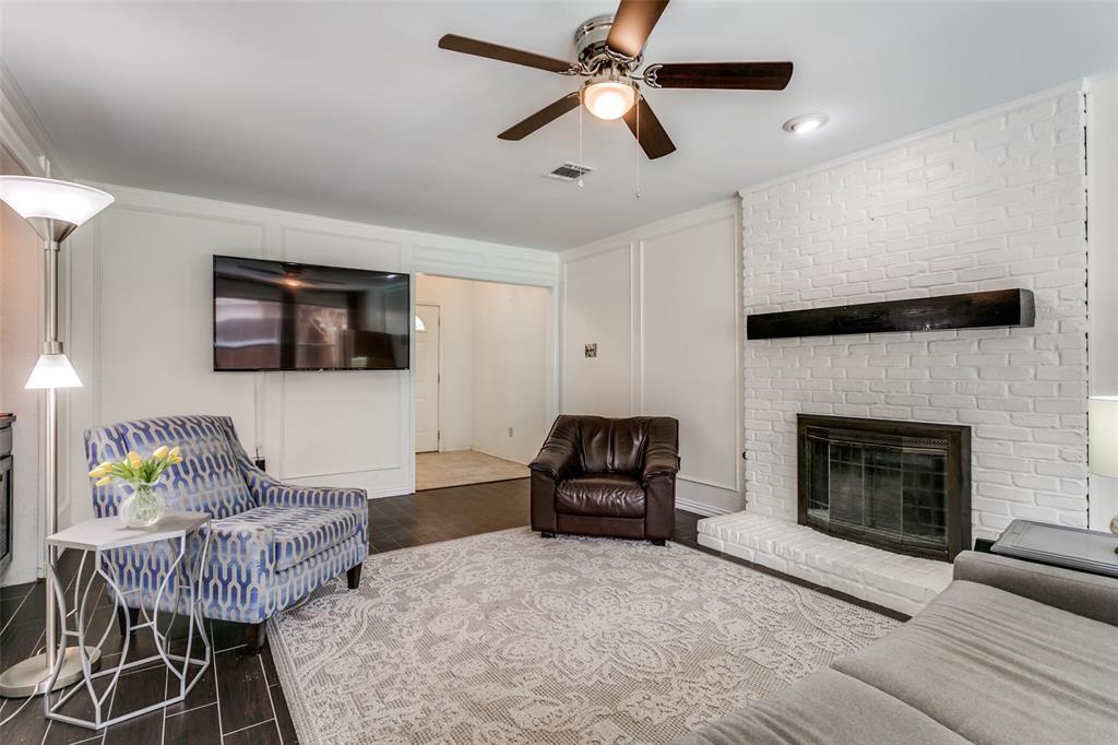 3438 Spring Willow Drive Grapevine, TX 76051 - Photo 6 of 27 a living room with furniture a flat screen tv and a fireplace