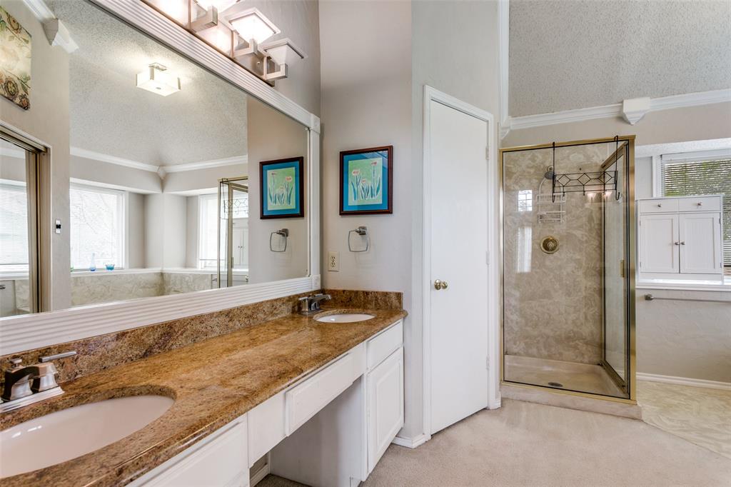 3438 Spring Willow Drive Grapevine, TX 76051 - Photo 10 of 23 Full bath with a textured ceiling, a shower stall, double vanity, crown molding, and light carpet