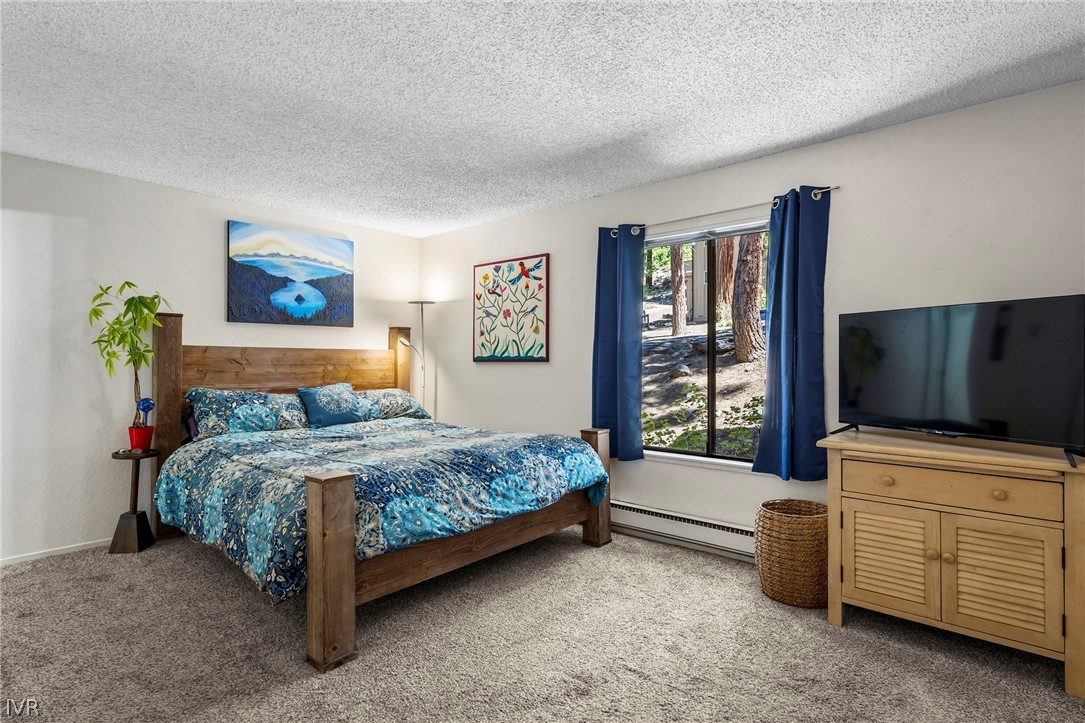 321 Ski Way, Unit 137 Incline Village, NV 89451 - Photo 15 of 21 a bedroom with a bed and a flat screen tv
