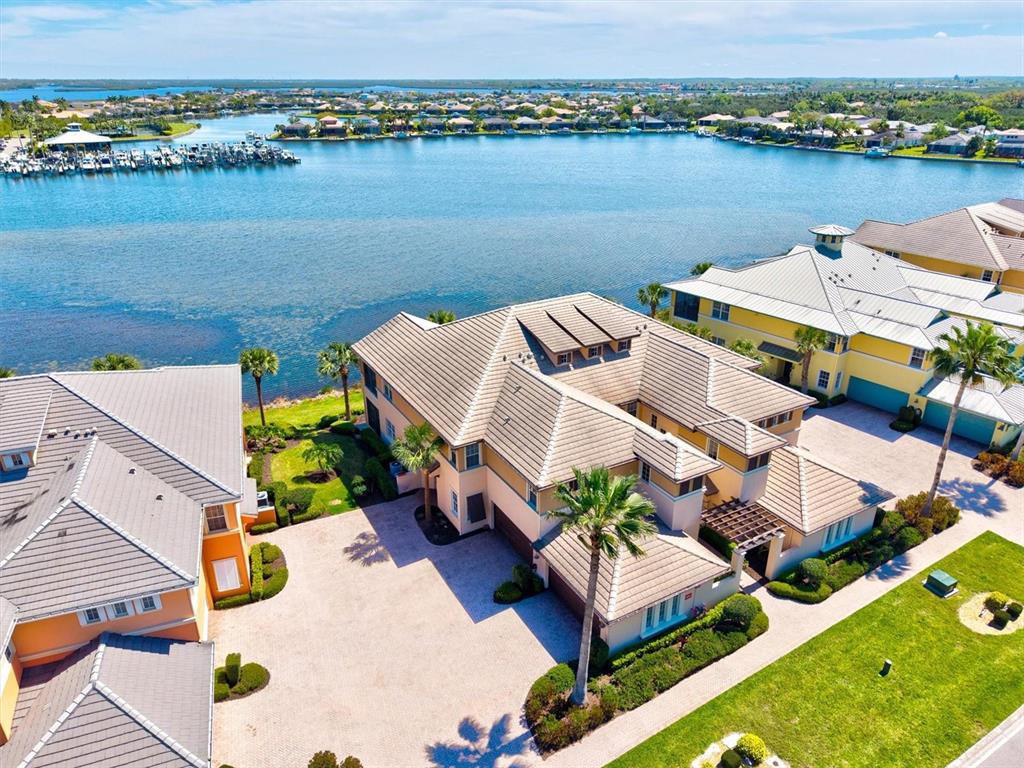 an aerial view of a house with outdoor space and lake view