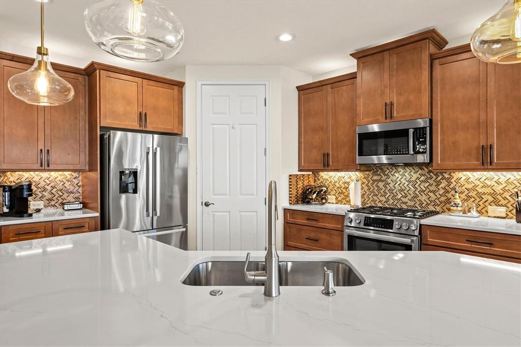 1135 Riverscape Street, Unit 1135 Bradenton, FL 34208 - Photo 13 of 100 a kitchen with stainless steel appliances granite countertop a refrigerator and a stove top oven