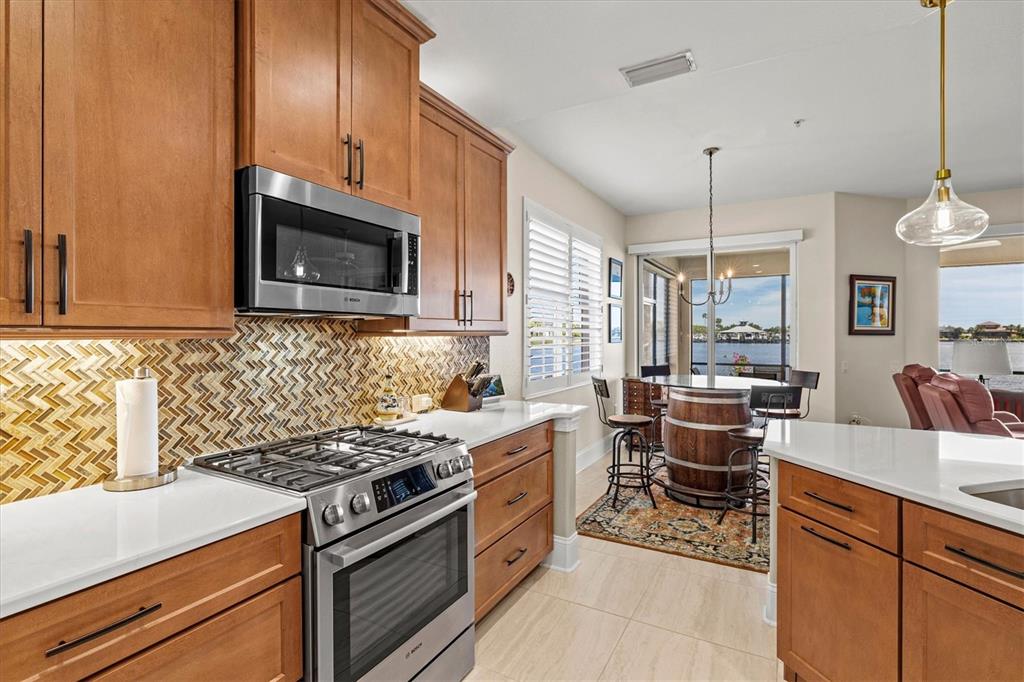 1135 Riverscape Street, Unit 1135 Bradenton, FL 34208 - Photo 16 of 100 a kitchen with stainless steel appliances a stove sink and cabinets