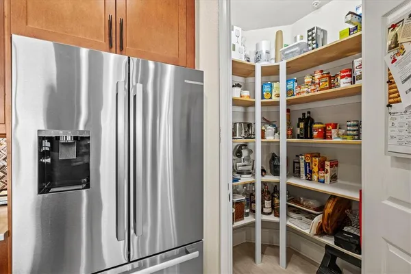 a dining room with furniture a chandelier and wooden floor