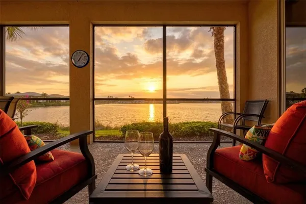 a view of a living room with furniture and floor to ceiling window