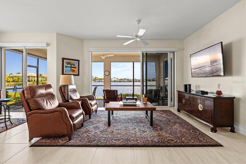 1135 Riverscape Street, Unit 1135 Bradenton, FL 34208 - Photo 22 of 100 a living room with furniture and a flat screen tv