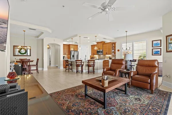 a living room filled with furniture and a floor to ceiling window