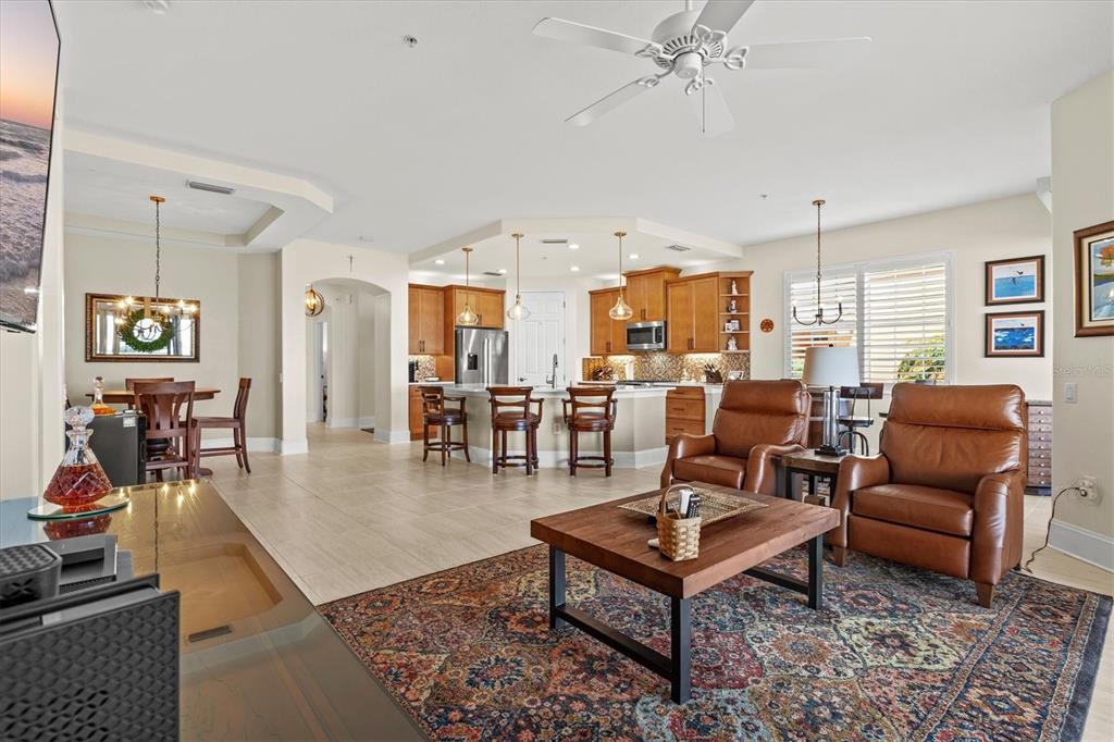 1135 Riverscape Street, Unit 1135 Bradenton, FL 34208 - Photo 24 of 100 a living room with furniture and a chandelier