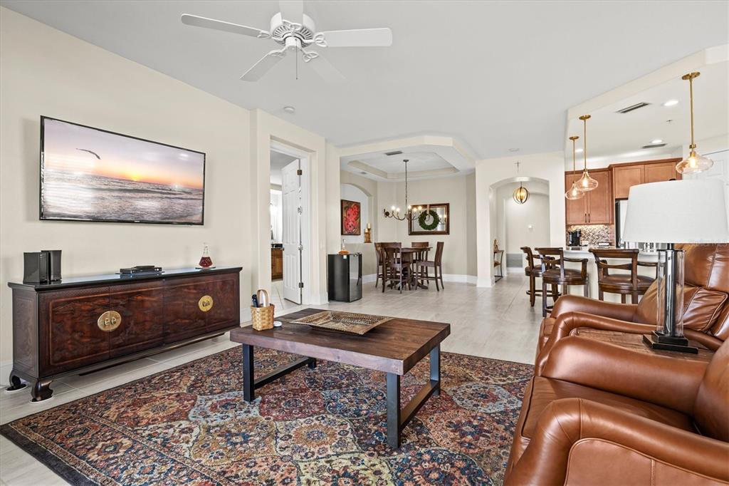 1135 Riverscape Street, Unit 1135 Bradenton, FL 34208 - Photo 25 of 100 a living room with furniture and a flat screen tv