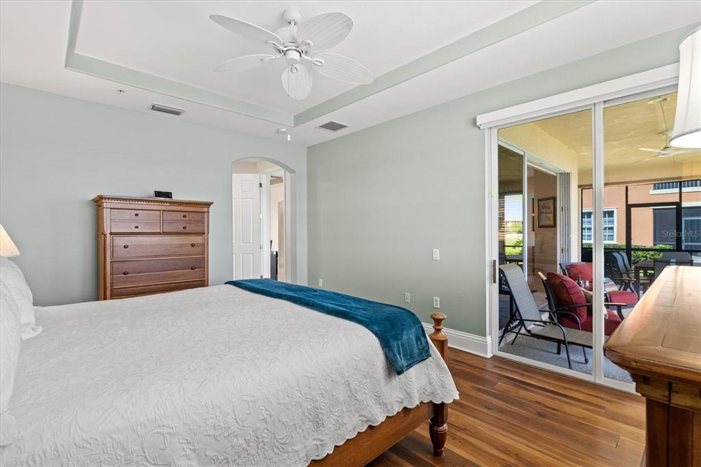 1135 Riverscape Street, Unit 1135 Bradenton, FL 34208 - Photo 30 of 100 a bedroom with a bed and wooden floor