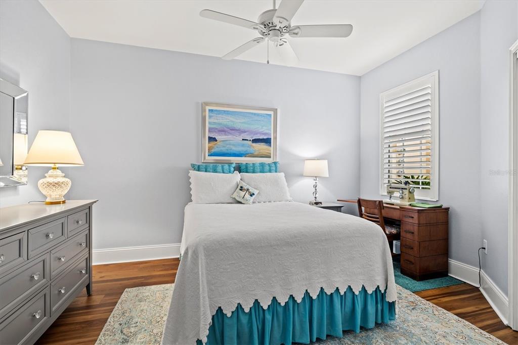 1135 Riverscape Street, Unit 1135 Bradenton, FL 34208 - Photo 34 of 100 a bedroom with a bed and a chandelier