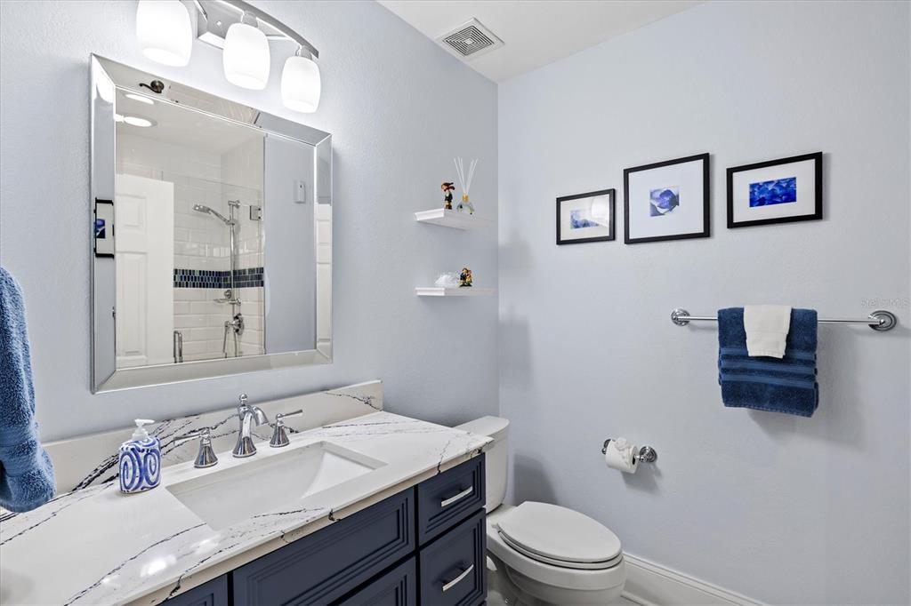 1135 Riverscape Street, Unit 1135 Bradenton, FL 34208 - Photo 36 of 100 a bathroom with a granite countertop toilet sink and mirror