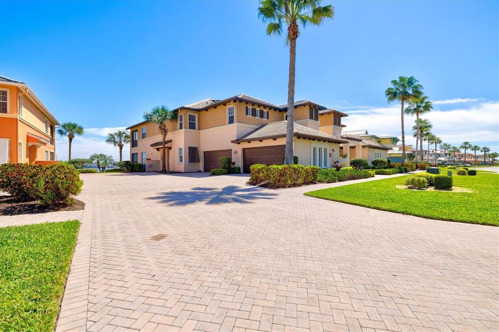 1135 Riverscape Street, Unit 1135 Bradenton, FL 34208 - Photo 4 of 100 a front view of a house with a garden and yard