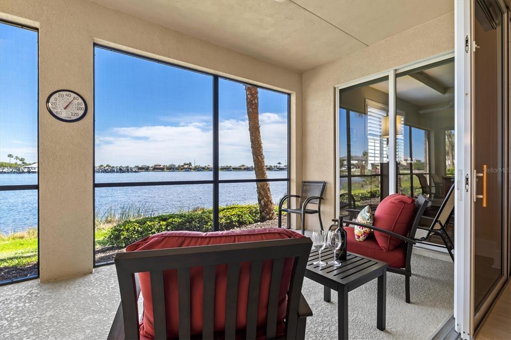 1135 Riverscape Street, Unit 1135 Bradenton, FL 34208 - Photo 42 of 100 a living room filled with furniture and a floor to ceiling window