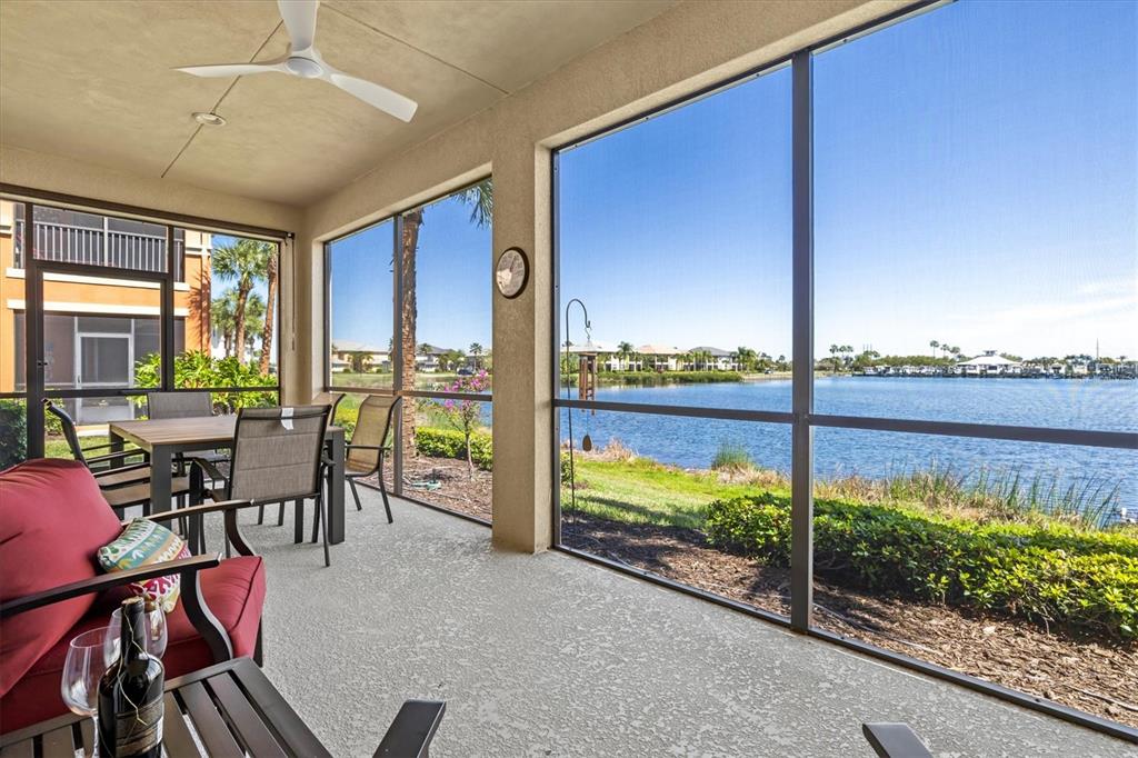 1135 Riverscape Street, Unit 1135 Bradenton, FL 34208 - Photo 44 of 100 a view of a living room and floor to ceiling window and an outdoor seating