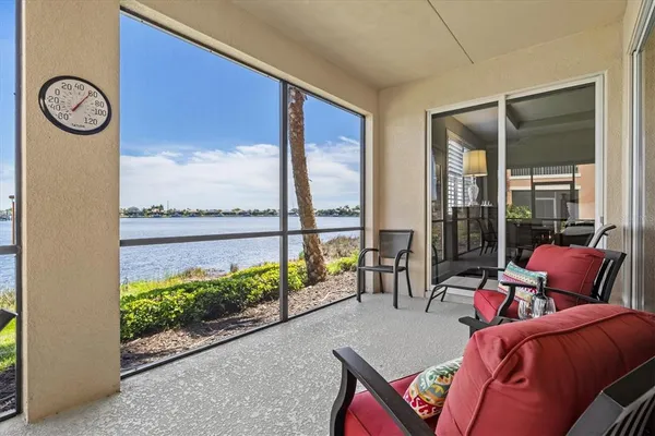 a view of a patio with a dining table and chairs with wooden floor