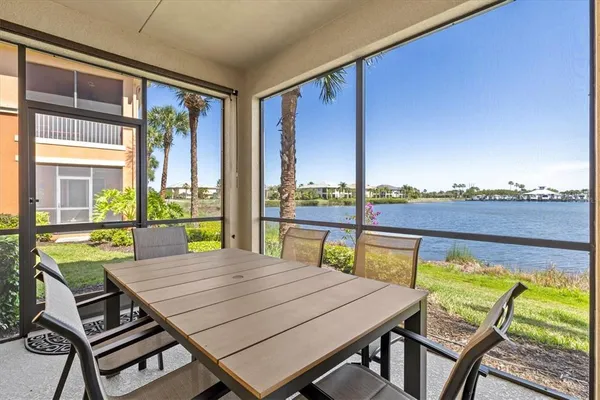 a view of a patio with dining table and chairs under an umbrella