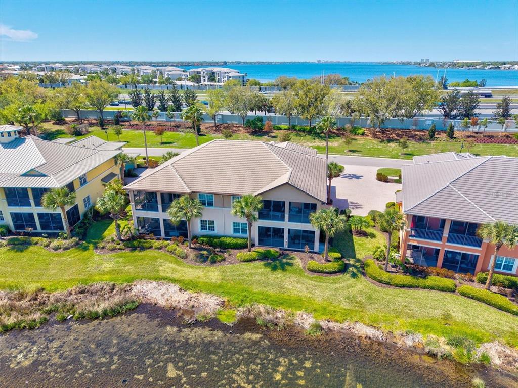 1135 Riverscape Street, Unit 1135 Bradenton, FL 34208 - Photo 60 of 100 an aerial view of a house with swimming pool garden and lake view
