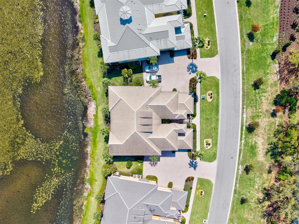 1135 Riverscape Street, Unit 1135 Bradenton, FL 34208 - Photo 61 of 100 an aerial view of a house with swimming pool and large trees