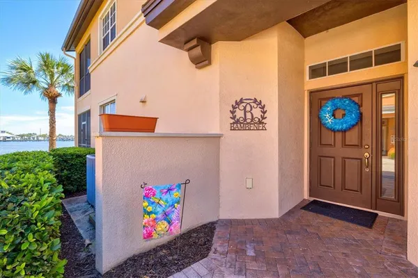 a kitchen with stainless steel appliances kitchen island granite countertop a table chairs and a refrigerator