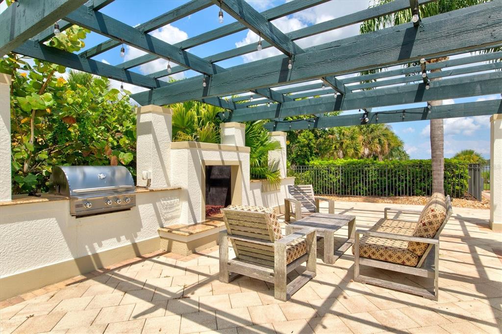 1135 Riverscape Street, Unit 1135 Bradenton, FL 34208 - Photo 79 of 100 a view of a patio with a dining table and chairs with wooden floor