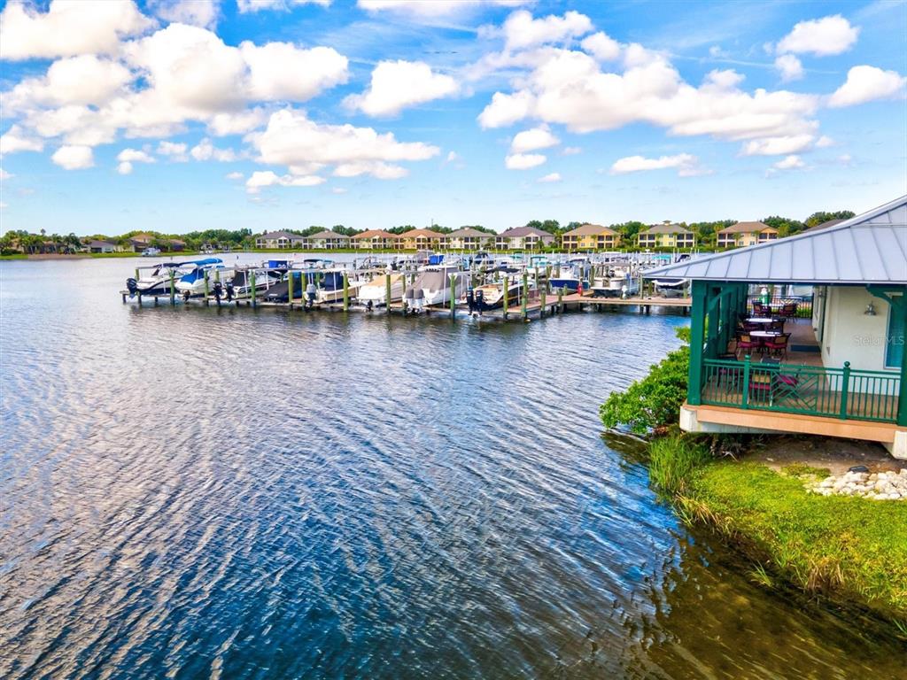 1135 Riverscape Street, Unit 1135 Bradenton, FL 34208 - Photo 86 of 100 a view of a lake with boats and trees in the background