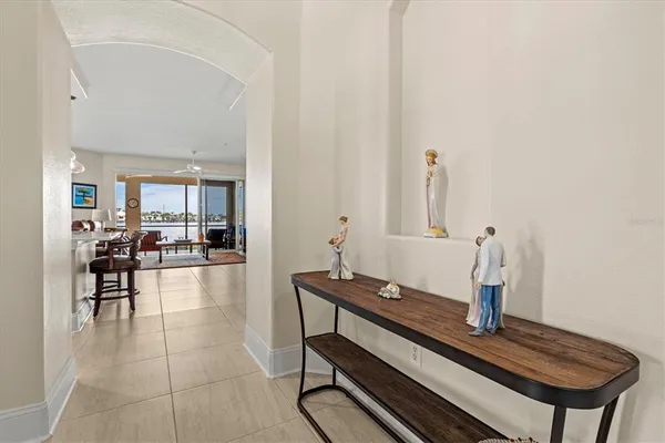 a kitchen with stainless steel appliances granite countertop a refrigerator a sink dishwasher a oven and a dining table with wooden floor