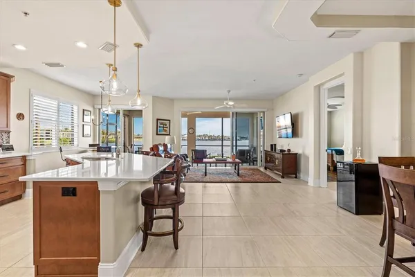 a kitchen with stainless steel appliances a refrigerator sink and microwave