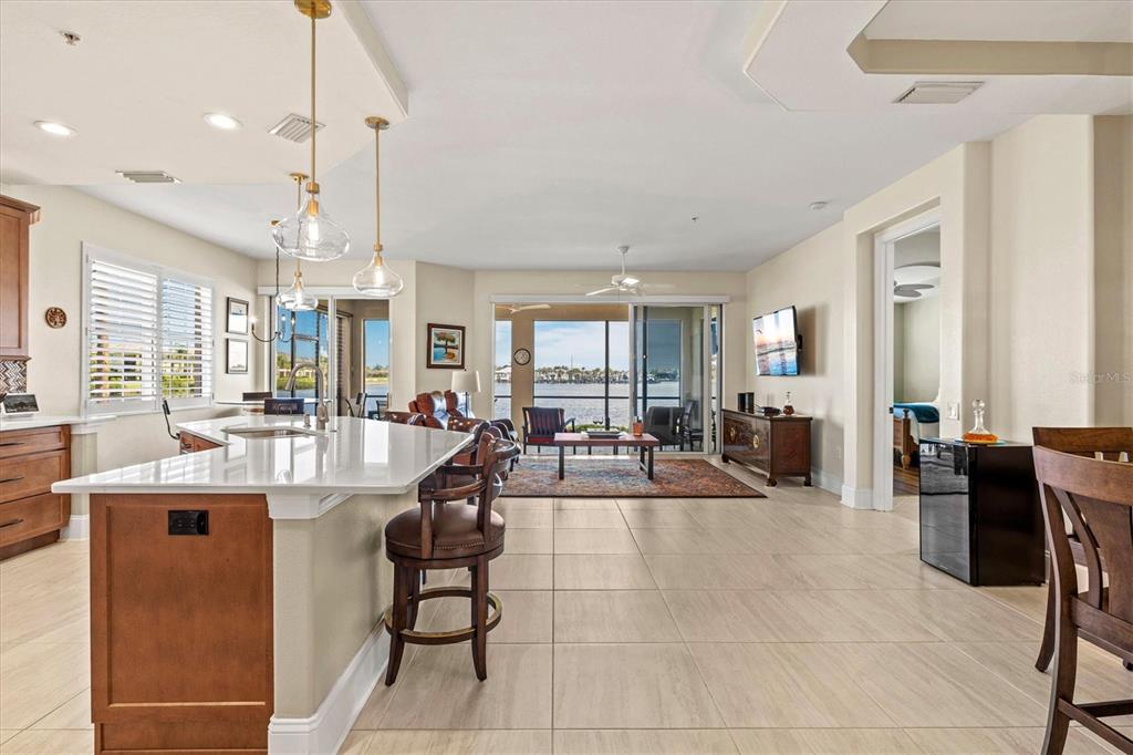 1135 Riverscape Street, Unit 1135 Bradenton, FL 34208 - Photo 10 of 100 a living room with lots of furniture and a large window