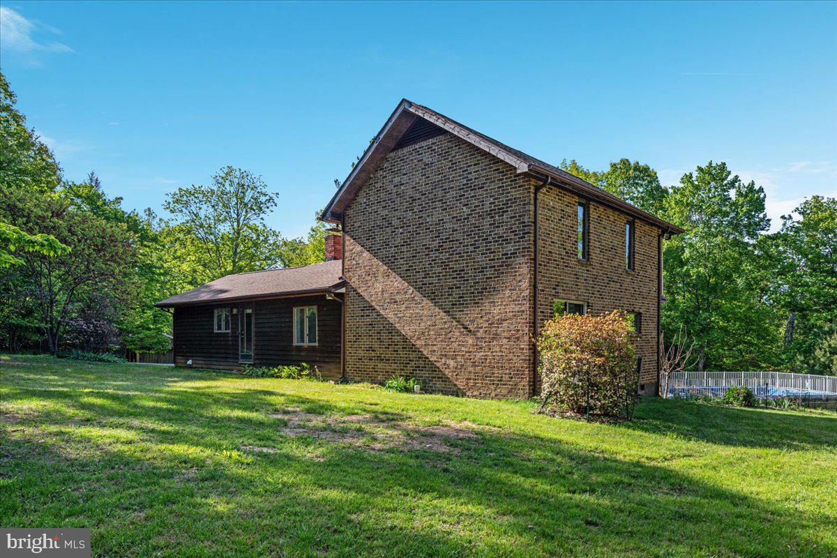 146 Lizzie Mills Road Castleton, VA 22716 - Photo 50 of 91 a view of house with backyard and a garden