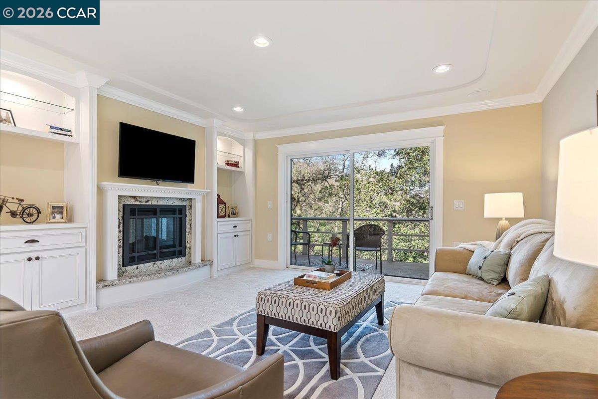 1332 Running Springs Road, Unit 1 Walnut Creek, CA 94595 - Photo 12 of 26 a living room with furniture a fireplace and a flat screen tv