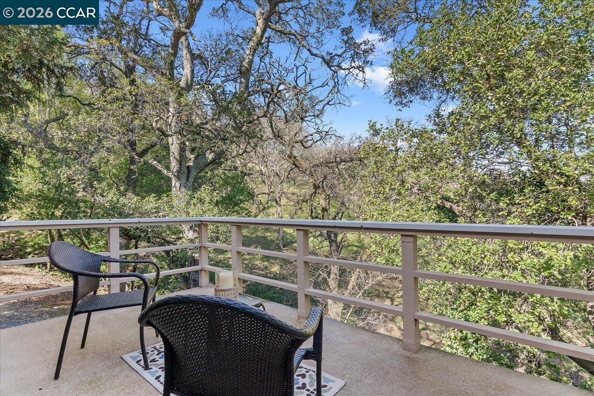 1332 Running Springs Road, Unit 1 Walnut Creek, CA 94595 - Photo 23 of 26 a view of a balcony with chairs and wooden fence