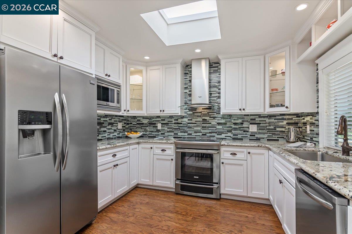1332 Running Springs Road, Unit 1 Walnut Creek, CA 94595 - Photo 7 of 26 a kitchen with stainless steel appliances granite countertop a sink stove and refrigerator