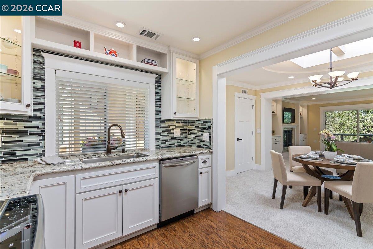 1332 Running Springs Road, Unit 1 Walnut Creek, CA 94595 - Photo 9 of 26 a kitchen with granite countertop kitchen island white cabinets and white appliances