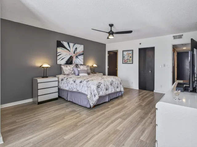 a bedroom with a bed and a large window